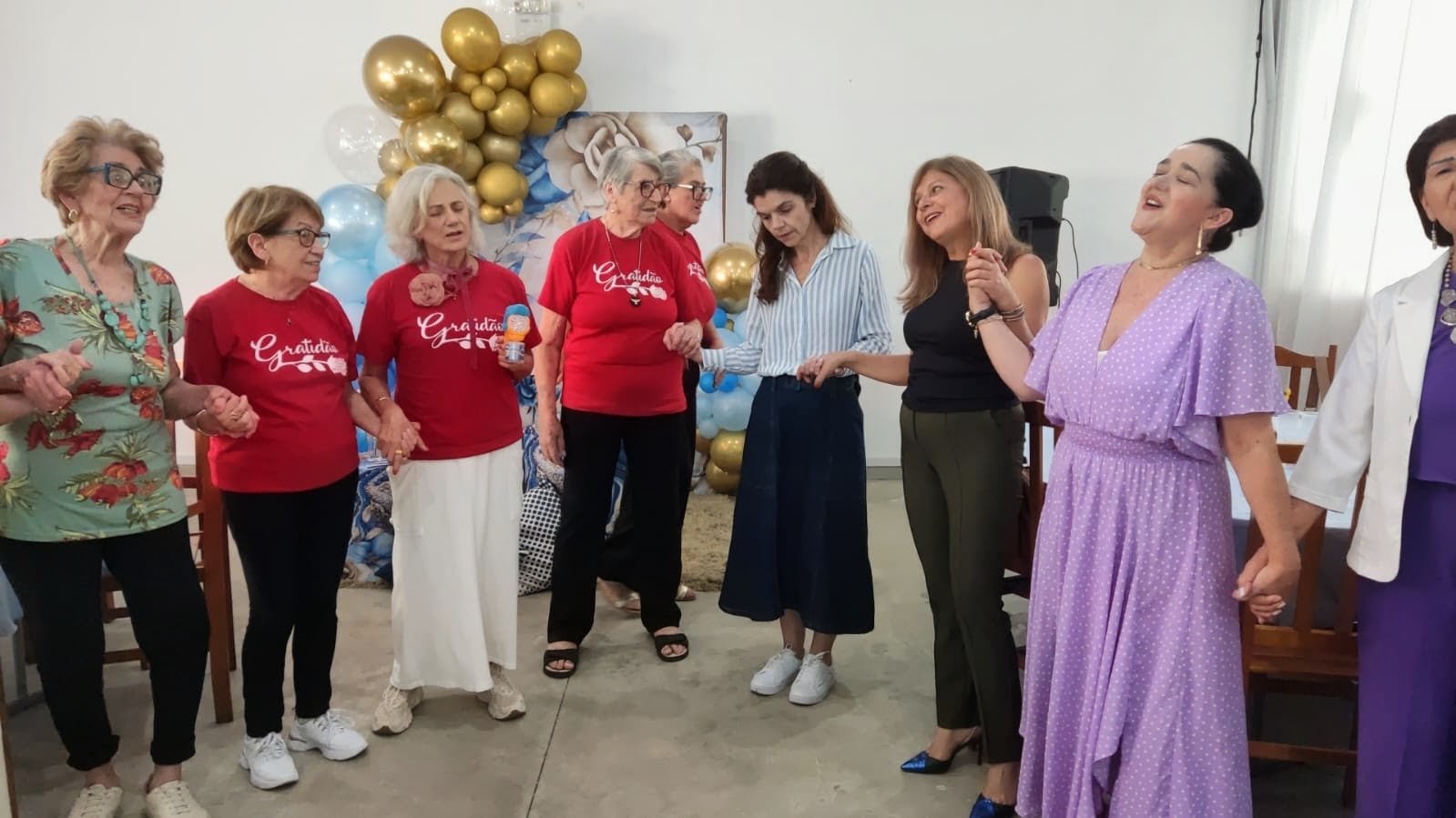 Círculo de mulheres de mãos dadas cantando juntas